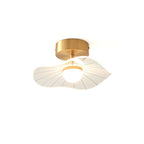 Brass-fitted ceiling light with a wavy ribbed shade and a glowing round bulb, on a plain white background, from Clérachic.