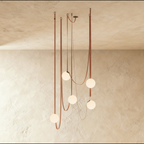 Clérachic chandelier with five frosted glass globe shades suspended on looping leather straps, unlit against a plaster ceiling.