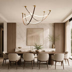 Above a long walnut dining table with cream chairs, this Clérachic three-loop pendant set hangs in crossing arcs of brown leather and light.