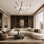 Clérachic loop pendants in a three-piece set, hung high over a curved cream sofa and a low round table in a living room.