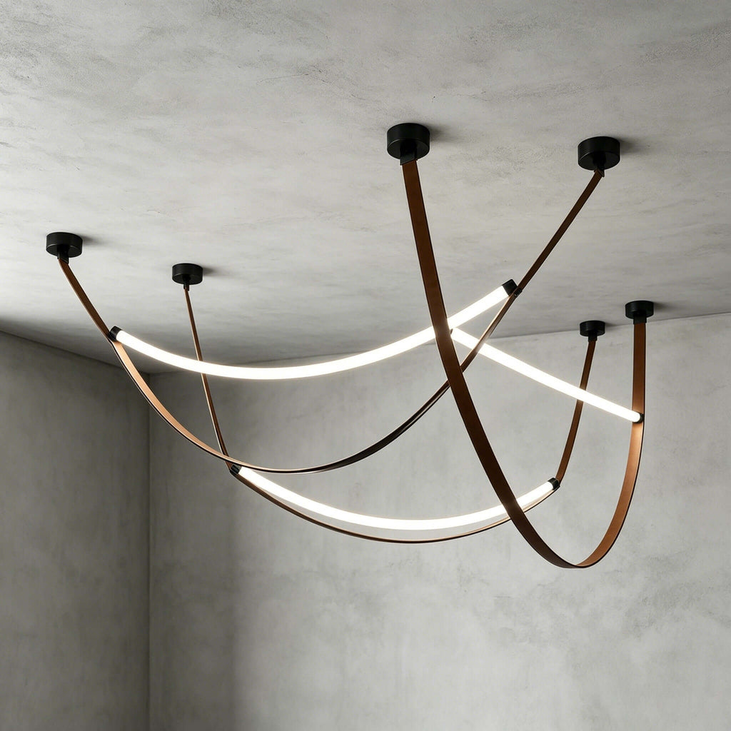 Black-capped Clérachic three-loop pendant set on a concrete ceiling, lit strips glowing between crossing brown leather straps.
