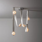 Clérachic Leather Strap Chandelier in white leather, straps threading through alabaster discs beneath a nickel ceiling plate.