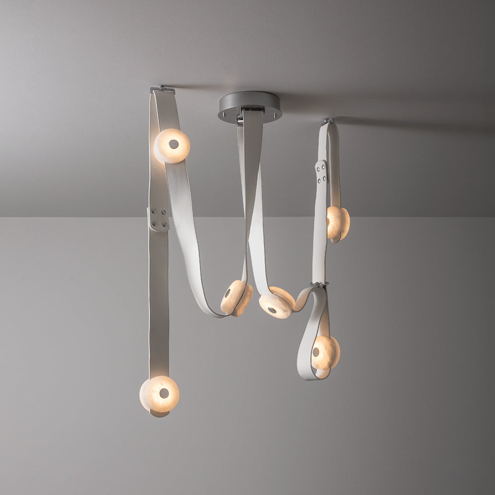 Clérachic Leather Strap Chandelier in white leather, straps threading through alabaster discs beneath a nickel ceiling plate.