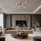 The Clérachic Leather Strap Chandelier in white leather lighting a large living room above a round walnut coffee table.