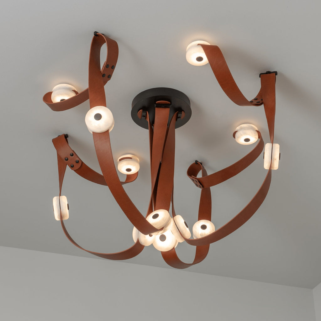 Looking straight up at the Clérachic Leather Strap Chandelier, tan leather looping around a black canopy of lit discs.