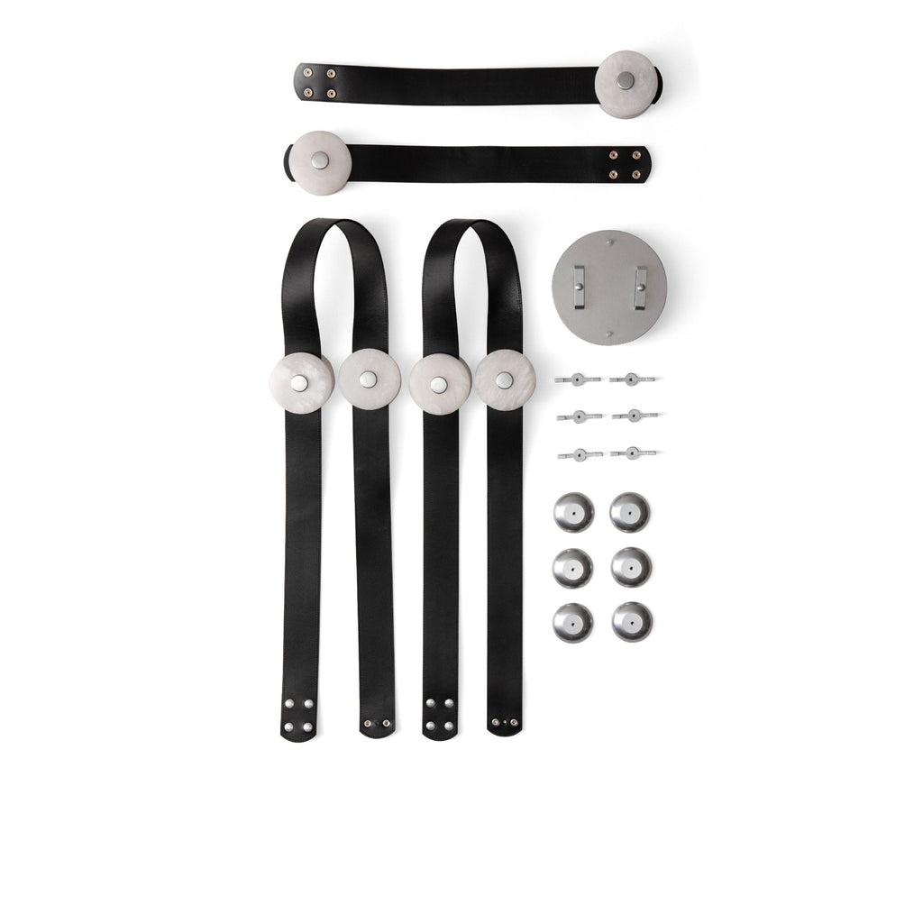 Flat lay of the Clérachic Leather Strap Chandelier parts, black straps, alabaster discs and a nickel canopy with fixings.