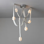 The 6-head Clérachic Leather Strap Chandelier in white leather, straps crossing below a chrome ceiling canopy.