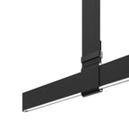 Close view of a black strap clasp gripping the flat light bar, with its lit edge showing, on this Clérachic pendant.
