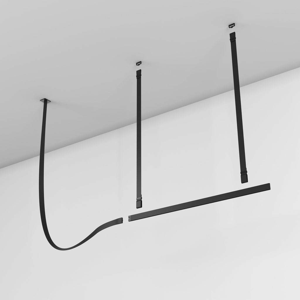 Black Clérachic strap pendant on a white ceiling, with its straps hanging and the light bar slightly apart from the curved strap.