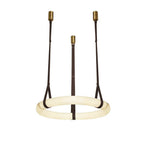 The Clérachic alabaster ring chandelier in its dark chocolate leather finish, three belts rising to slim brass ceiling canopies.