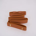 Tan cognac leather belt for the Clérachic ring chandelier, coiled flat with double stitching and two brass rivets at the end.