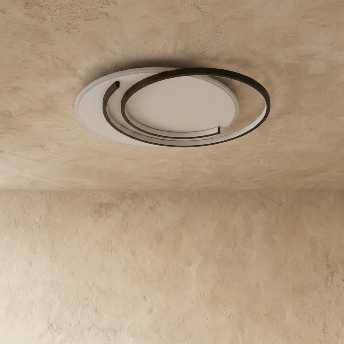 Clérachic flush ceiling light with black ring frames in a crescent layout and an unlit white diffuser, on limewash.