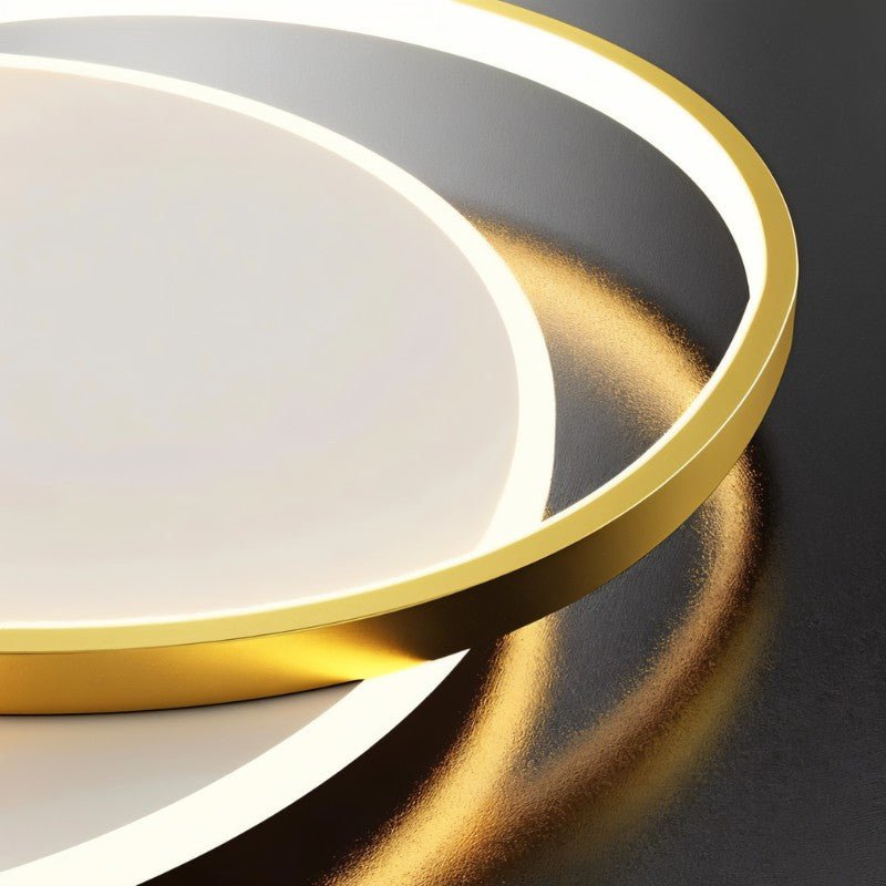Clérachic close view of the gold aluminium ring edge beside the lit white diffuser of the flush ceiling light.