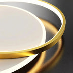 Clérachic close view of the gold aluminium ring edge beside the lit white diffuser of the flush ceiling light.