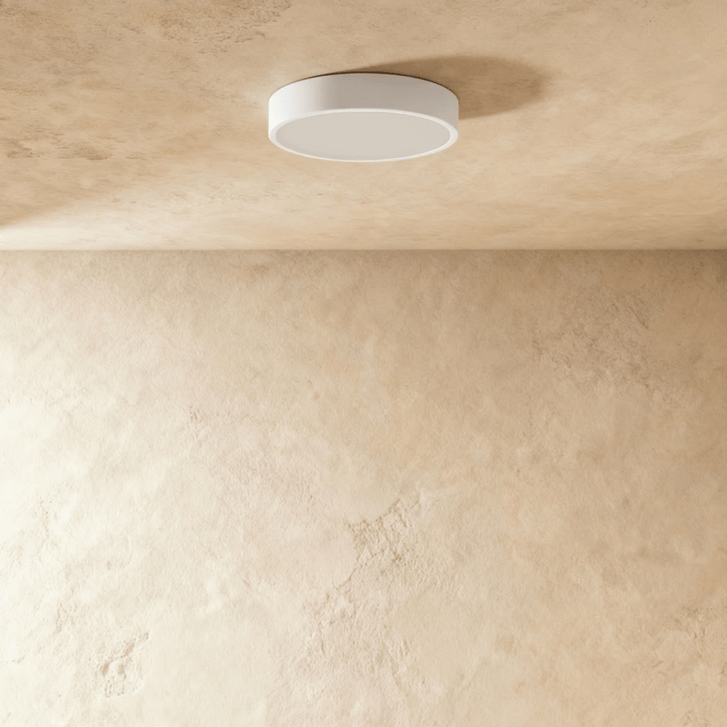 Clérachic round white surface-mounted LED downlight switched off, showing its flat frosted diffuser and slim white rim.