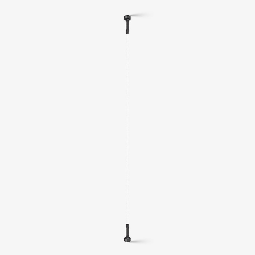 This Clérachic strip ceiling light on a plain white backdrop, a thin white band held taut between two black end brackets.