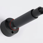 Close view of the black round end bracket and tube that anchor this Clérachic strip light to the wall.