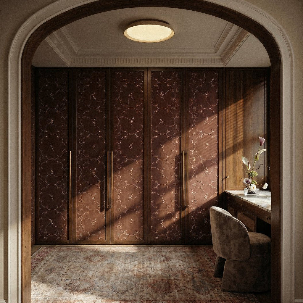 Clérachic round flush ceiling light glowing softly in a panelled dressing room with carved cornice, dark wood wardrobes and arched doorway.