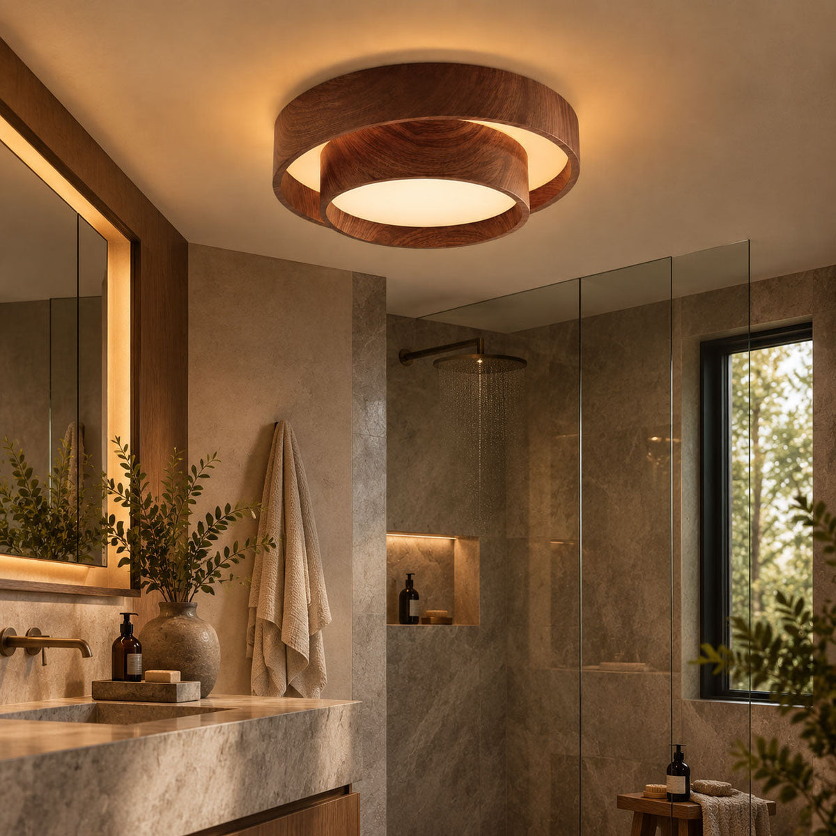 Clérachic wood-grain ceiling light in a bathroom with a stone vanity, a glass shower screen, a framed mirror and a folded towel.