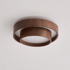Unlit Clérachic ceiling light on a pale ceiling, with a wide walnut wood-grain ring and a narrower ring below, around a white diffuser.