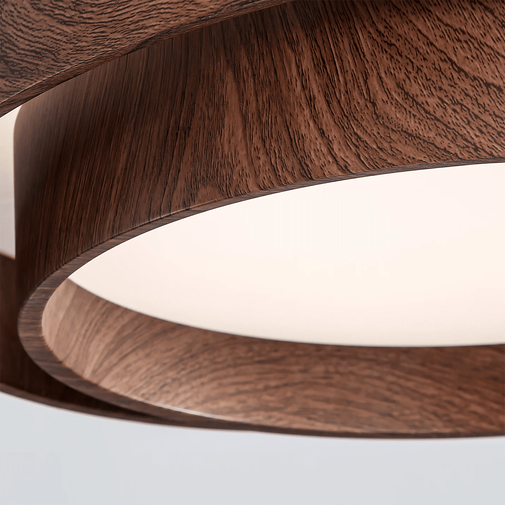 Close view of the layered wood-grain rings of this Clérachic ceiling light, with the matt white diffuser seen from below.