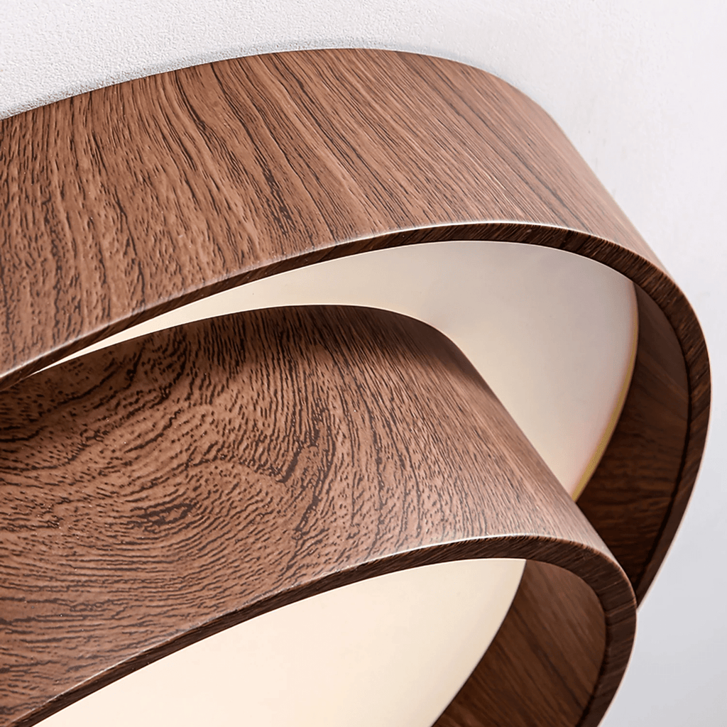 Close view of the fine walnut grain pattern and curved edge of the stacked rings on this Clérachic ceiling light.