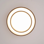 Clérachic ceiling light seen from directly below, lit, with an outer ring, a glowing white band and a smaller inner ring.