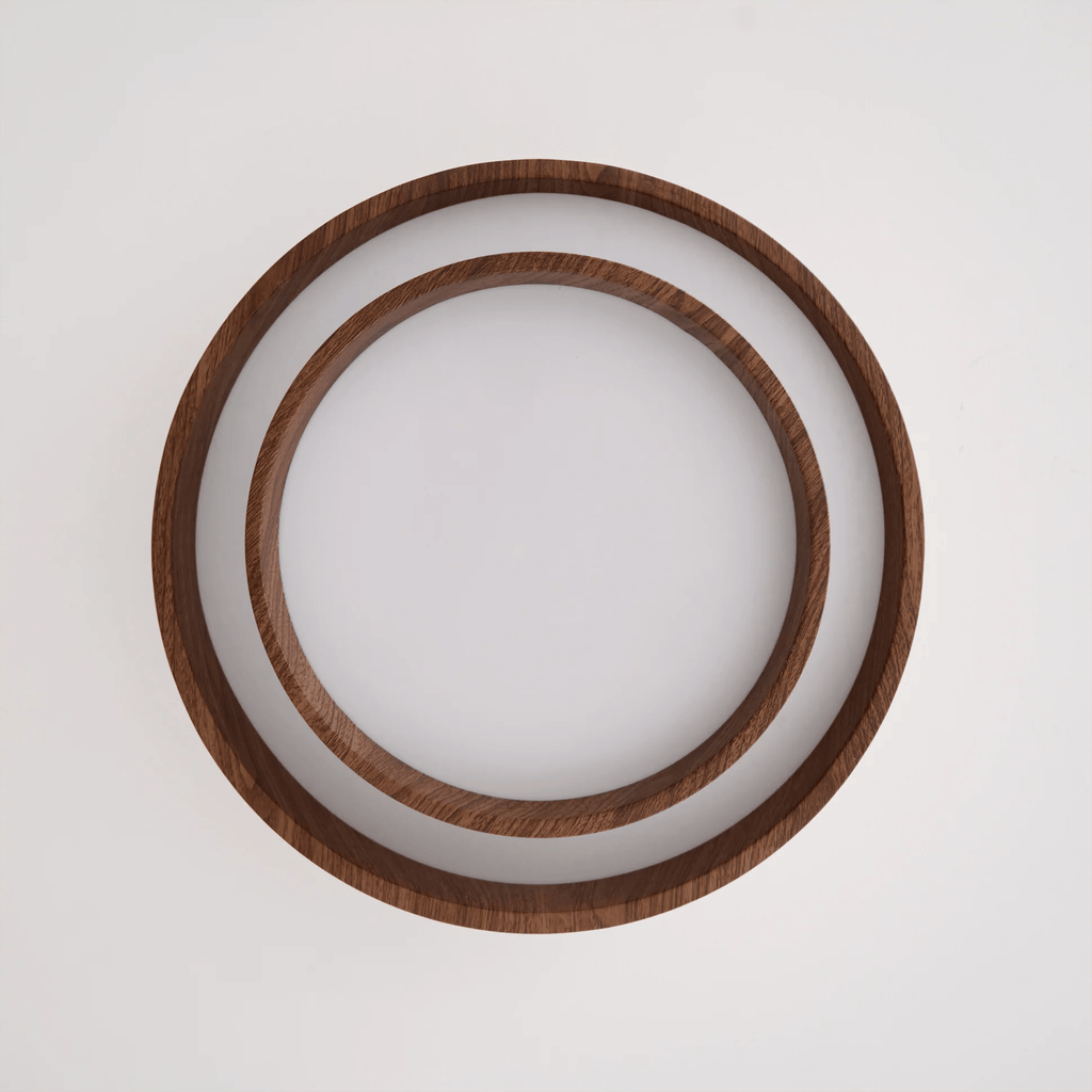 Clérachic ceiling light seen from directly below, unlit, showing two concentric wood-grain rings around a white diffuser.