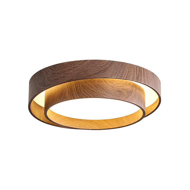 Wider Clérachic ceiling light on a white backdrop, lit, with a golden glow between its walnut-look rings.