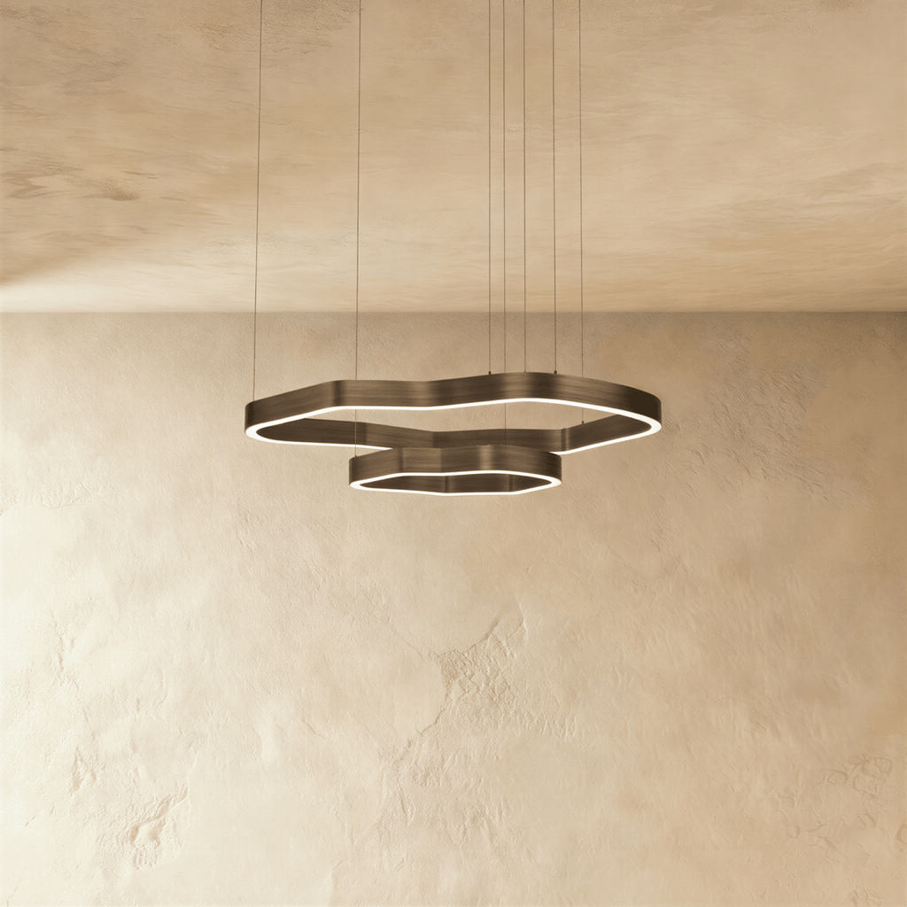 Clérachic two-ring LED chandelier with irregular wavy rings in dark bronze metal, glowing softly on fine suspension cables.