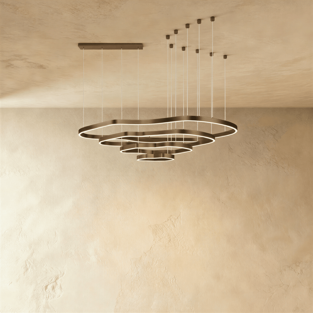 Clérachic four-ring LED chandelier of stacked wavy bronze rings on cables, with a rectangular and a multi-point ceiling canopy.