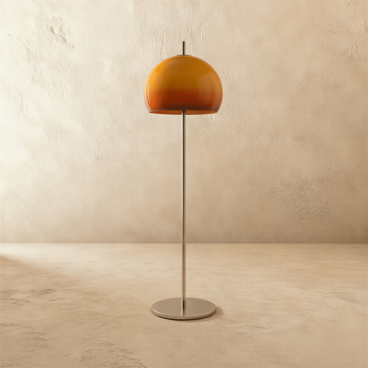 Clérachic floor lamp with an amber-orange glass dome, unlit, on a thin brushed chrome stem and round base.