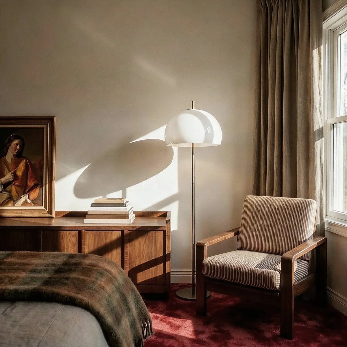 Clérachic floor lamp with a white domed shade beside a walnut sideboard and a wooden armchair in a sunlit bedroom.