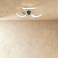 Clérachic ceiling fan with a light in white: interlocking looped LED bands around a central fan, seen in a studio.