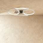 Clérachic larger white ceiling fan with a light in studio view, its looped LED bands wide around the central fan blades.