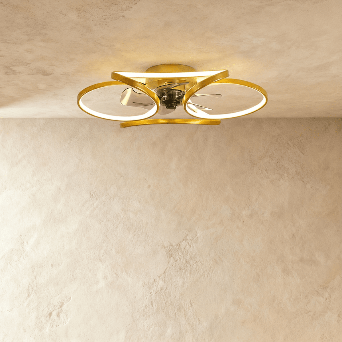 Clérachic larger gold ceiling fan with a light, wide looped LED bands around the central fan in studio light.