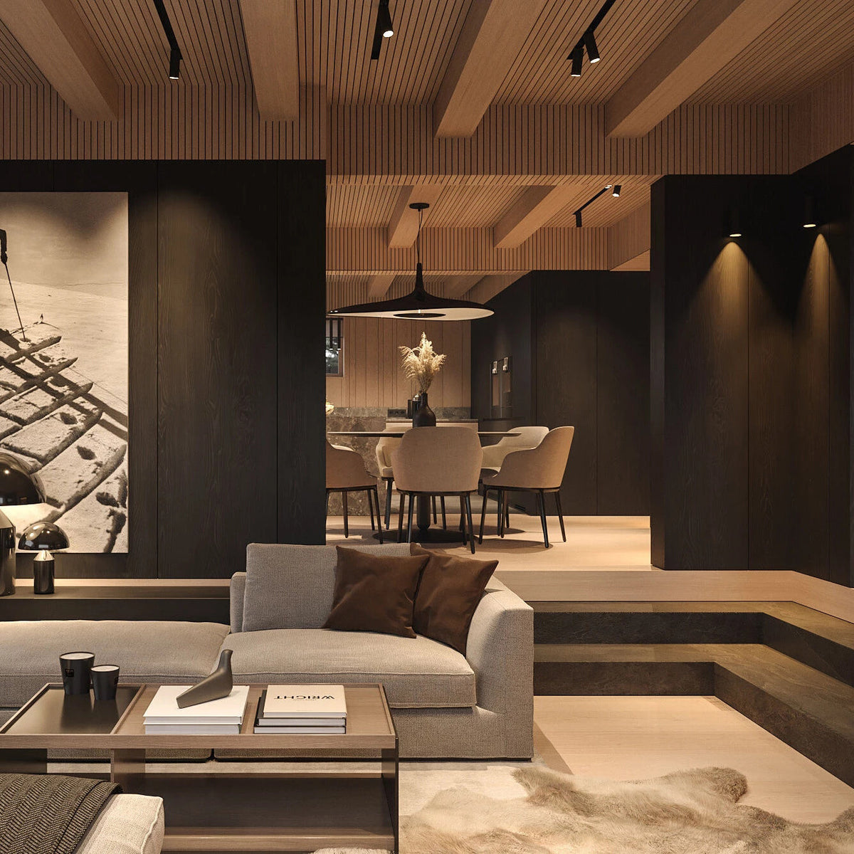 A black disc pendant hangs in a dark panelled interior with a timber-slat ceiling and a grey sofa in the foreground, from Clérachic.