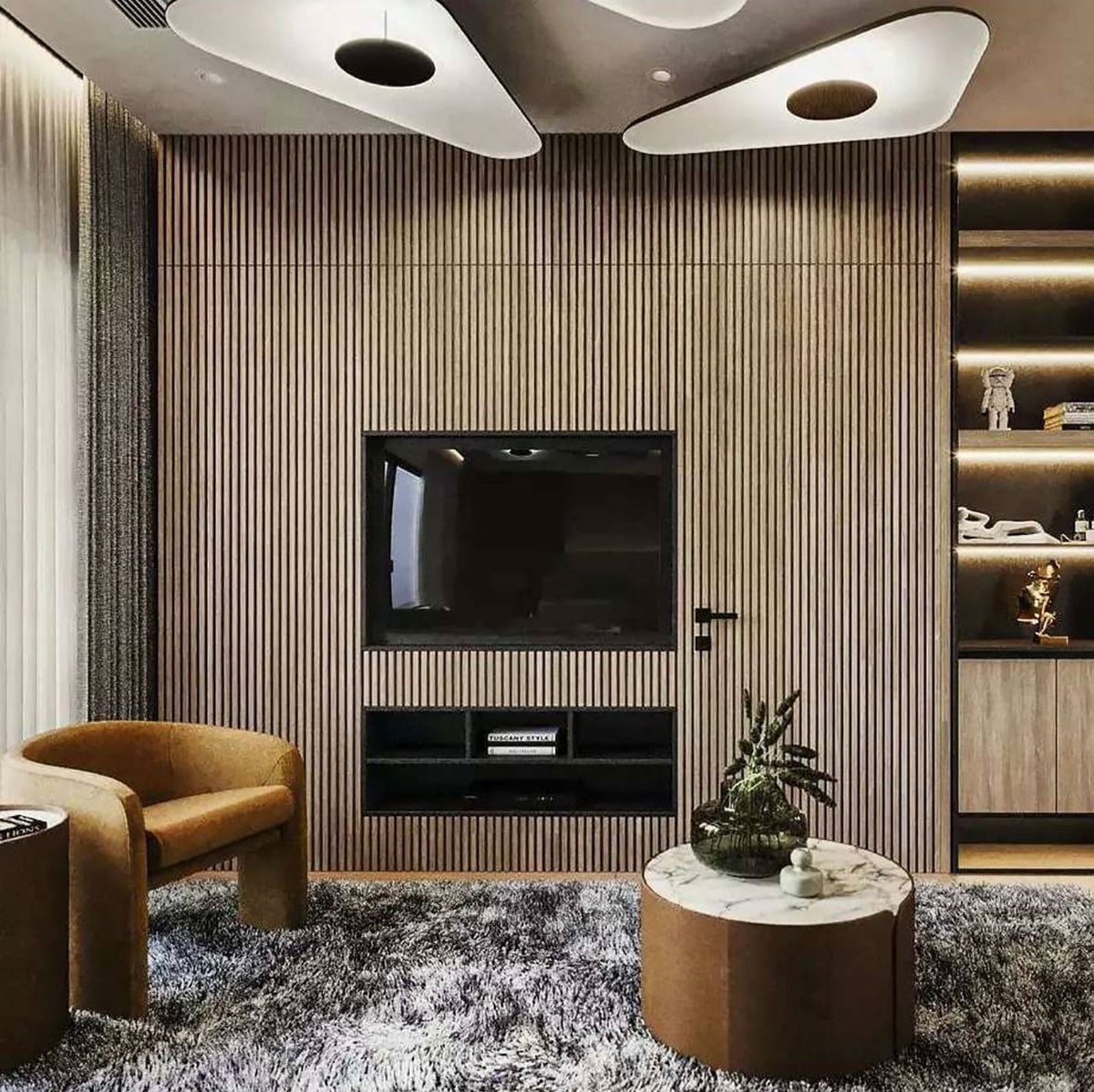 Two white triangular-edged disc pendants glow above a timber-slat wall with a television and a tan armchair, shown with this Clérachic pendant.
