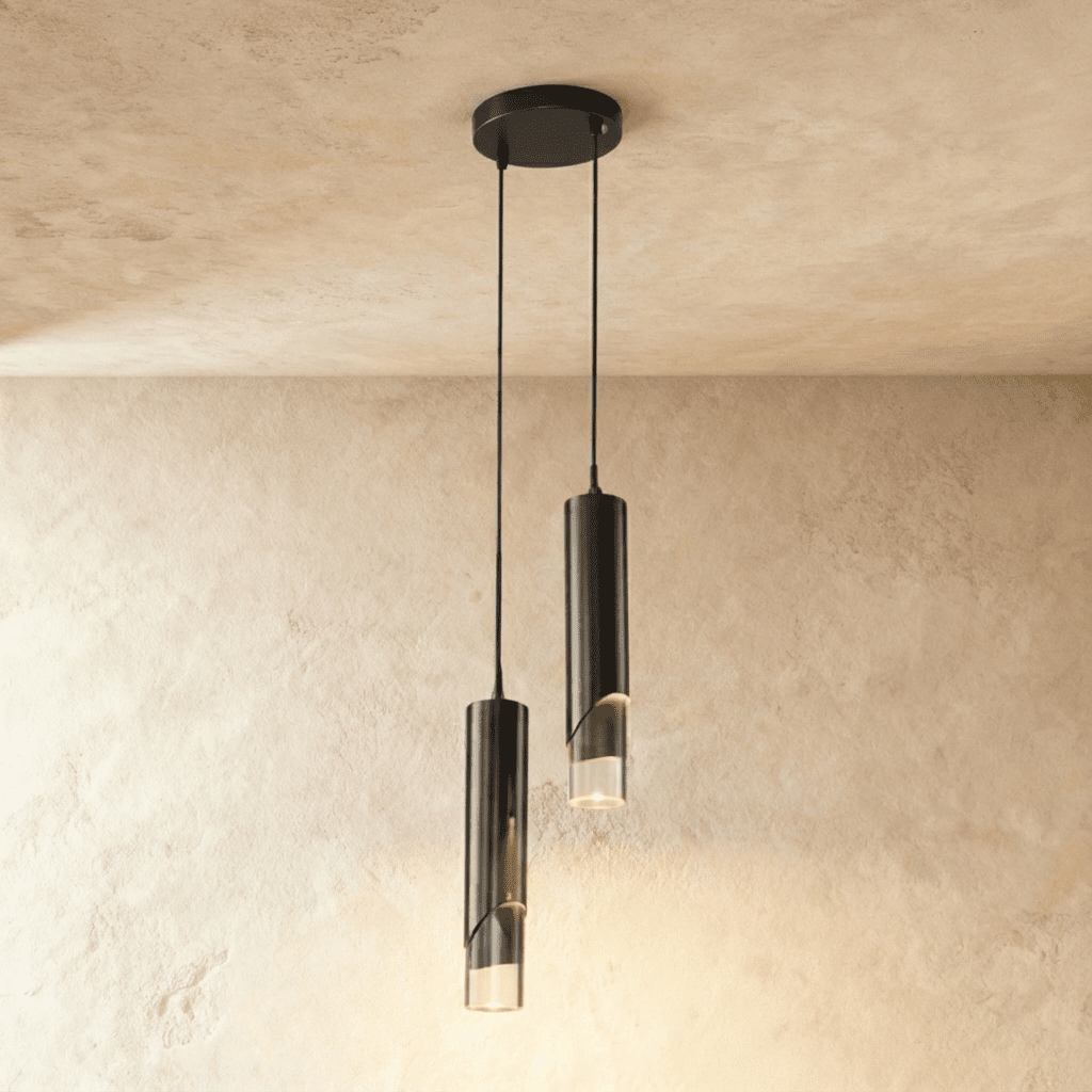 Clérachic two-head pendant light with black metal cylinders and clear glass tips hanging from a round black ceiling plate.