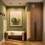 Clérachic black-coned recessed downlights in a hallway ceiling beside a green plaster wall, a framed floral painting and a bench.