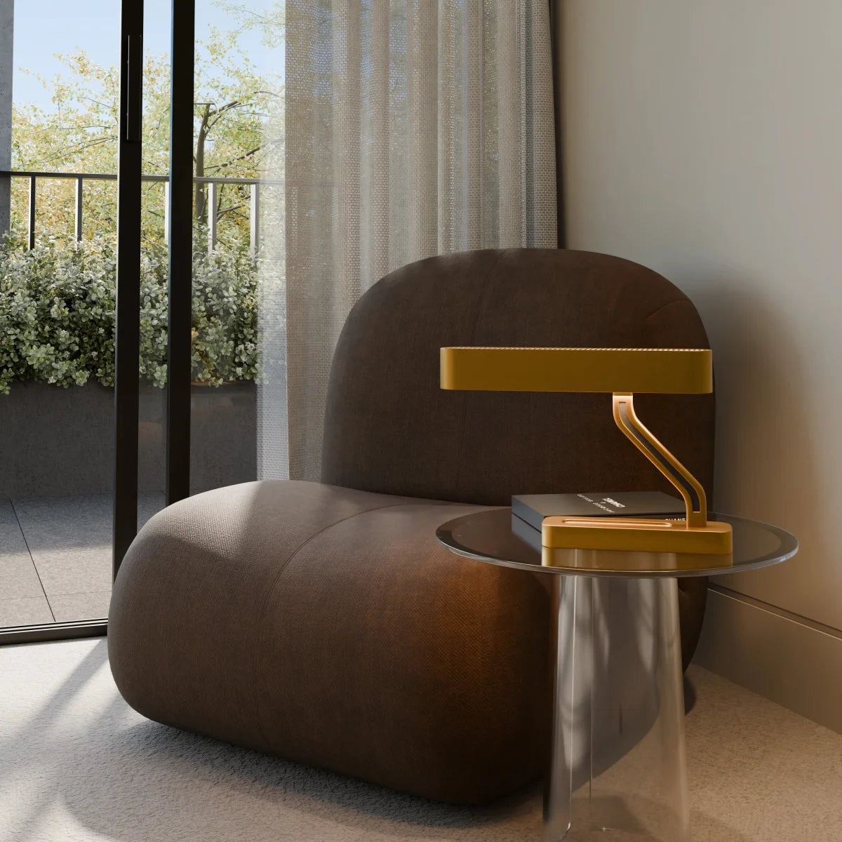Clérachic gold Z-arm table lamp on a glass side table beside a brown rounded armchair and a sheer curtain.