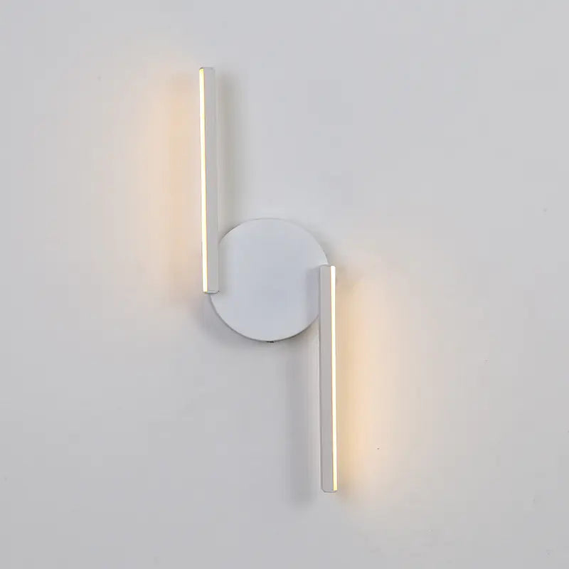 Clérachic wall light in matt white, two straight bars glowing on a plain wall, one set above the round backplate and one below.