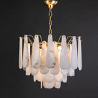 Clérachic Leon chandelier, tiered alabaster teardrops hung from a brass chain on black.