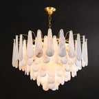The Clérachic Leon chandelier on black, its stone drops layered in three deep tiers.