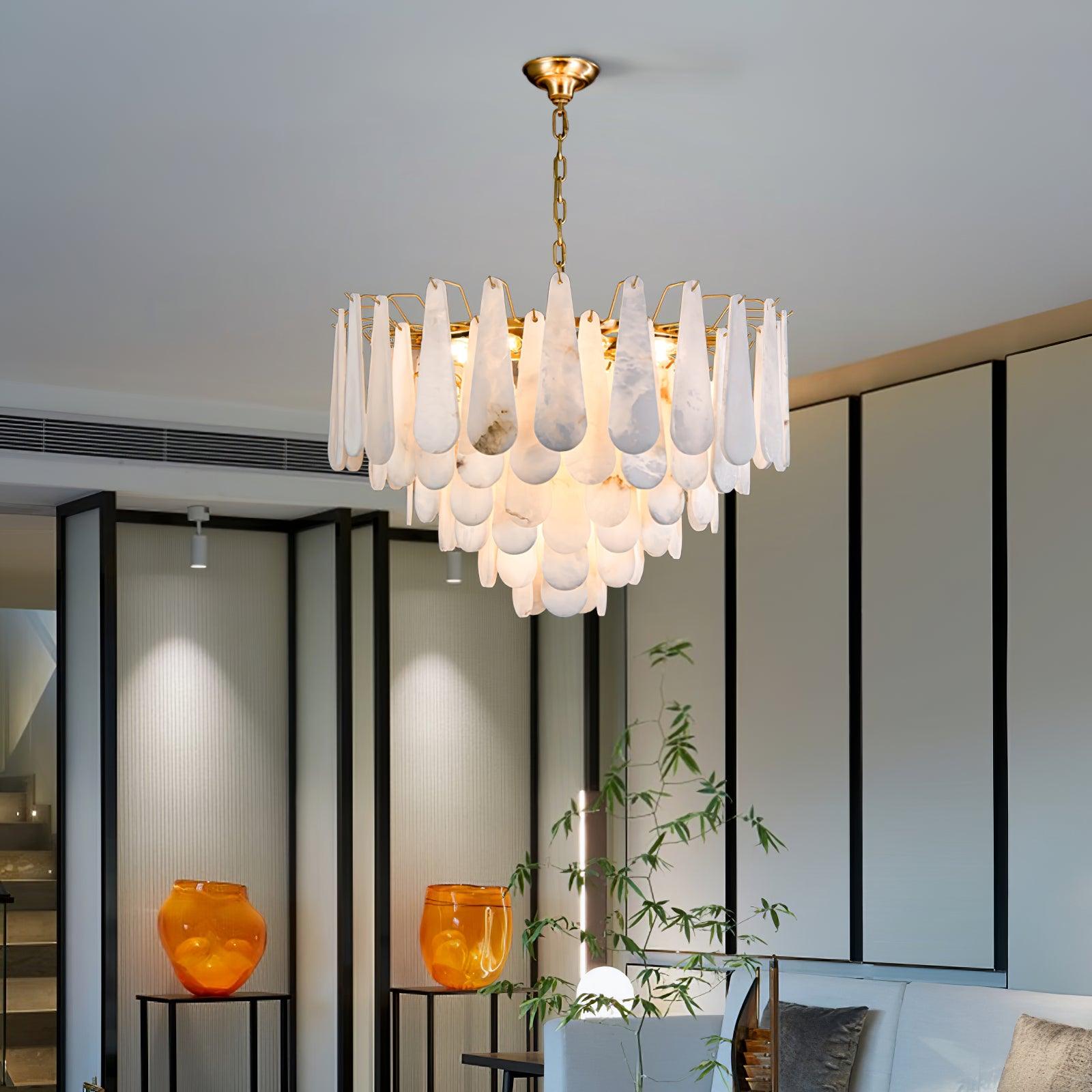 The Clérachic Leon chandelier lit in a room with black screens and amber glass vases.