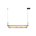 Front view of the Clérachic Linear Alabaster LED Pendant Light against white, the glowing bar suspended between two brass droppers for a dining table.