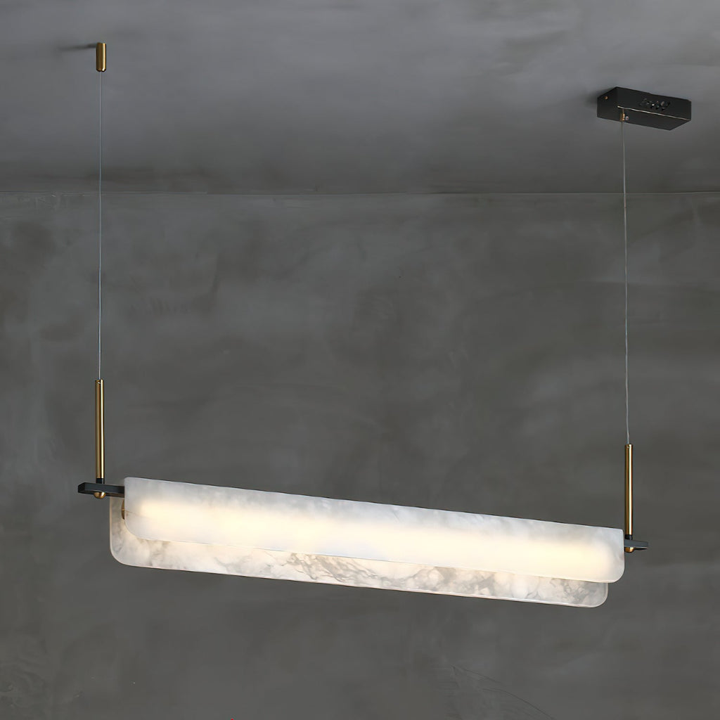 The Clérachic Linear Alabaster LED Pendant Light hung from a raw concrete ceiling, its veined stone bar glowing warm along its full length.