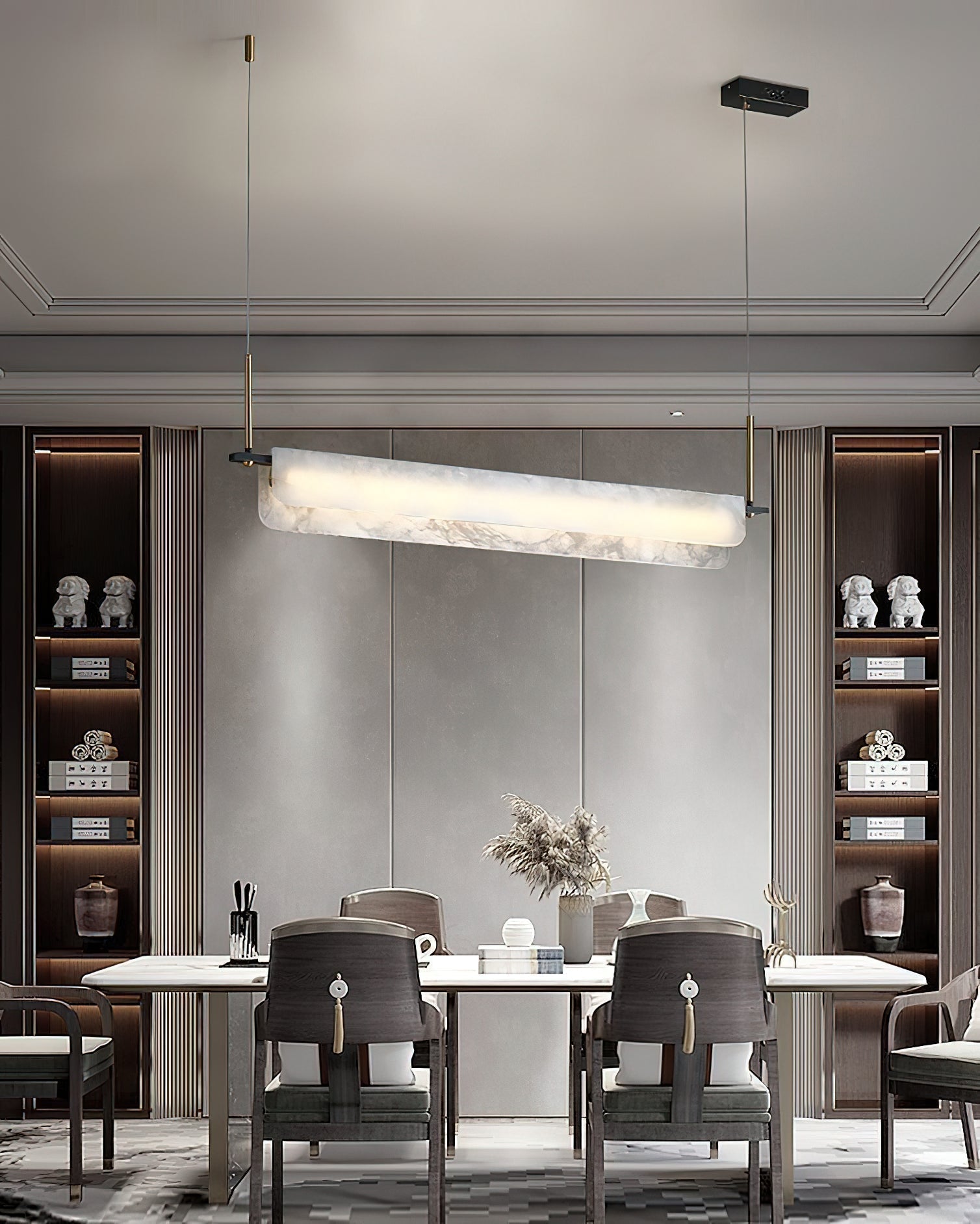 Clérachic Linear Alabaster LED Pendant Light spanning a formal dining table, its lit bar echoing the pale marble top and lit display cabinets.