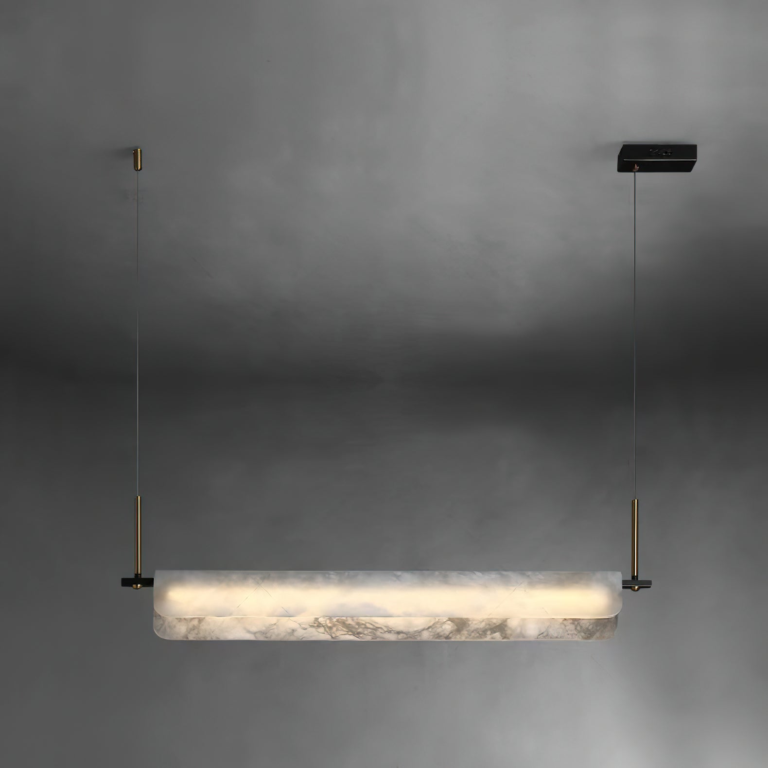 Clérachic Linear Alabaster LED Pendant Light on a soft grey studio backdrop, the full bar lit and hung level from its black driver box.