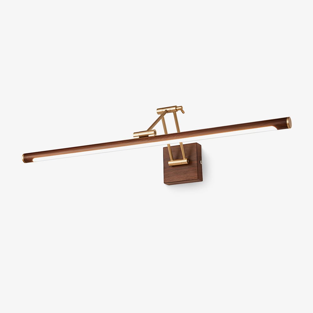A Clérachic linear wall light on a plain pale backdrop, with a walnut-toned tube, a brass folding arm and a square walnut wall block.